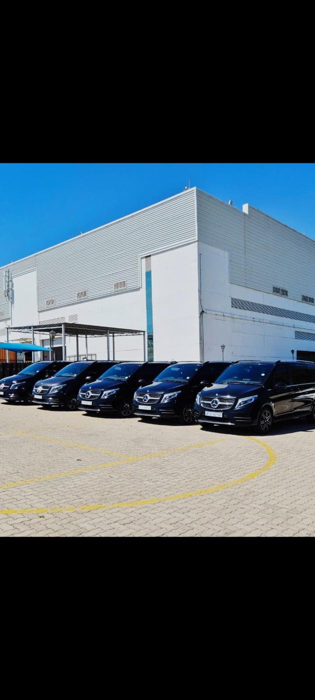 Vehicle fleet parked at night outside a venue